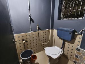 a small bathroom with a toilet and a shower at Kanasu guest house in Gokarna +40 photos