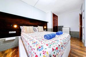 a bedroom with a large bed with blue towels on it at Cocoteros Ocean View House in Guatiza