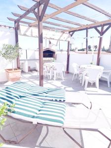 a bed on a patio with tables and chairs at Casa ryli in Torrevieja