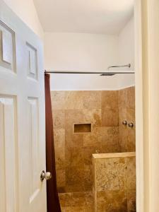 a bathroom with a shower with a shower curtain at Maya Bric in Playa del Carmen +36 photos