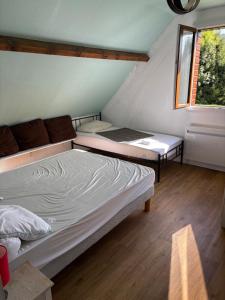 a bedroom with a bed and a window at Chalet Louise 16 personnes - 5 chambres in Murat-le-Quaire