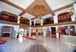 a large room with a large ceiling and a lobby at Hotel Nouzha in Fez