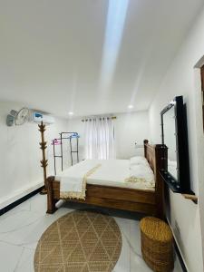 a bedroom with a bed and a tv in a room at Darajani Apartment in Zanzibar City +26 photos
