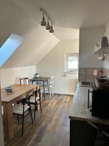 a kitchen and dining room with a table and chairs at Ubytování Otín in Jindrichuv Hradec