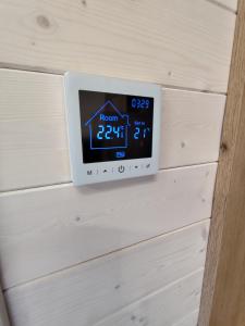 an alarm clock on the wall of a house at Dauny House - Dein Tiny House Erlebnis in der Vulkaneifel in Daun