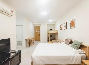 a white bedroom with a bed and a fireplace at Riverine Diamond 7 RDB Studio CK - Free 1 Parking, Netflix & Cozy Retreat Couples, Families in Kuching