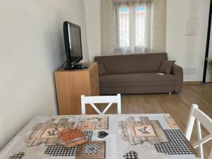 a living room with a table and a couch at Is Bangius in Bacu Abis