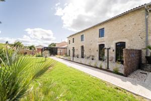 an external view of a brick building with a yard at Domaine du Vieux Porche in Mignaloux-Beauvoir