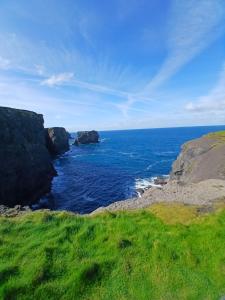 a view of the ocean with rocks in the water at 2 Cois Farraige in Kilkee