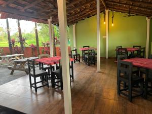 a group of tables and chairs in a restaurant at Hotel 14 Pods Morjim in Morjim