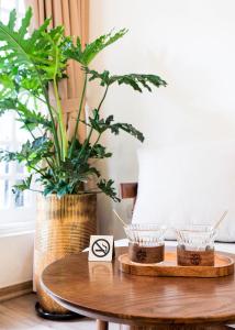 a wooden table with two bowls on it with a plant at Maison Maravelle Hotel - Boutique Stay in Hanoi Old Quarter in Hanoi +15 photos