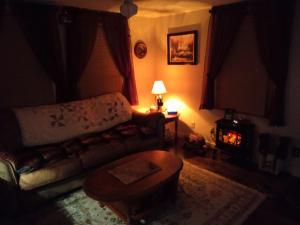 a living room with a couch and a coffee table at Cozy 2 Bedroom Home in Madison