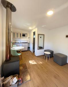 an empty living room with a kitchen and a dining room at Cabaña Ensenada, Puerto Varas - 1 ambiente in Puerto Varas +12 photos