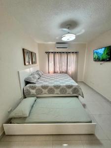 Postel nebo postele na pokoji v ubytování Your ideal escape in Puerto Plata Beach and fun