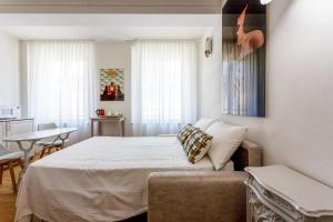 Postel nebo postele na pokoji v ubytování Dimora d'autore - L'arte di Vivere Modena + 23 fotografií