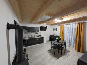 a kitchen with a stove and a table in a room at Apartmány U Lazara in Kutná Hora