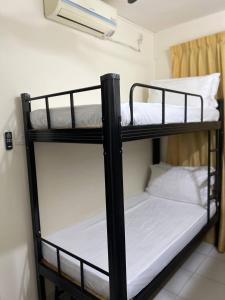 two bunk beds in a room with white sheets at ValueRoomz Aeon Tebrau City IKEA G2S NOW Ready in Johor Bahru