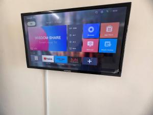 a flat screen tv hanging on a wall at ValueRoomz Aeon Tebrau City IKEA G2S NOW Ready in Johor Bahru