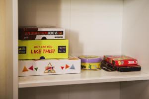 a shelf with books and boxes on it at Korea town in Prague
