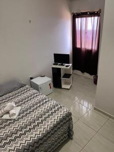 Ένα ή περισσότερα κρεβάτια σε δωμάτιο στο Pousada santos