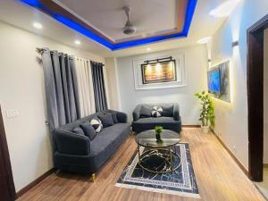 a living room with a couch and a table at Modern 2BHK Islamabad in Islamabad +18 photos