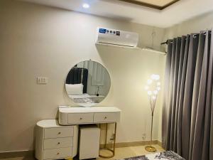 a bathroom with a sink and a mirror at Modern 2BHK Islamabad in Islamabad