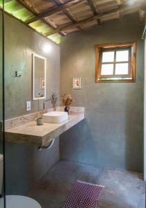 a bathroom with a sink and a mirror at Akasha Atelier Sana in Sana