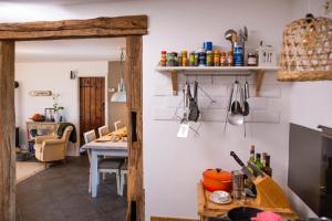 a kitchen with a table and a dining room at Villa Souvenir, Lenax in Lenax