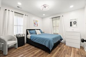 a bedroom with a bed and a chair at Spacious 3BR,3BA Modern Home in Decatur