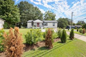 a white house with a yard with bushes at Spacious 3BR,3BA Modern Home in Decatur