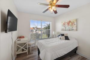 a bedroom with a bed and a ceiling fan at Apollo Beach Waterfront 4BR with Dock and Near Tampa in Apollo Beach