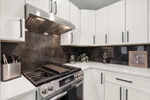 a kitchen with white cabinets and a stove top oven at Spacious 3BR 3BA Home Modern Renovation in Decatur