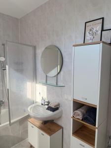 a bathroom with a sink and a mirror at Ferienwohnung Stein-16 zum Prinzenweg in Oberhof