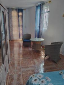 a living room with chairs and a table in a room at Azure nest in Cap Malheureux