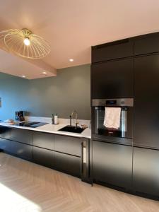 a kitchen with a sink and a stove at Nice and modern apartment in Stavanger