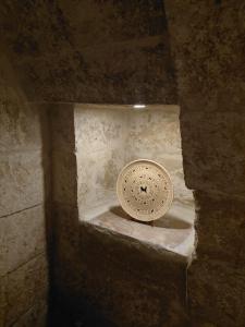 a stone wall with a light at the top of it at Cappadocia Masuer House in Ürgüp
