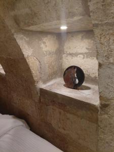 a room with a horse statue in a stone wall at Cappadocia Masuer House in Ürgüp