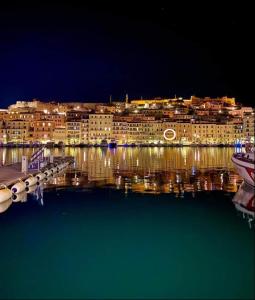 a view of a city at night from the water at Casa Calata in Portoferraio