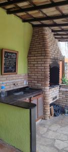 a brick oven with a table in front of it at Espacio chill hostel in Búzios