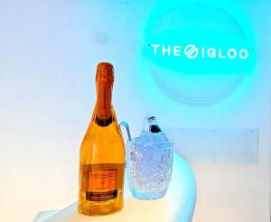 a bottle of alcohol next to a glass at The Igloo Milano -Luxury Eclectic Suite - Jacuzzi - MilanoFlats in Milan