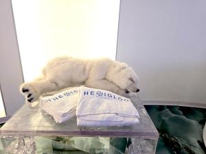 a white polar bear laying on a table with towels at The Igloo Milano -Luxury Eclectic Suite - Jacuzzi - MilanoFlats in Milan