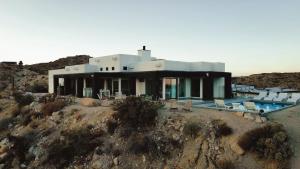 a house on top of a hill with a pool at Aquarius By The Cohost Company in Yucca Valley