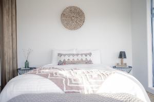 a white bedroom with a large bed with white sheets at Aquarius By The Cohost Company in Yucca Valley +69 photos