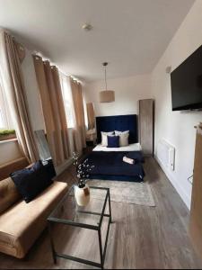 a living room with a bed and a couch at Stylist Ground-Floor Studio Near City Centre in Portsmouth