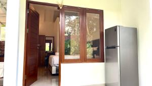 a kitchen with a refrigerator in a room at Tegala Home in Payangan