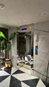 an elevator in a building with a potted plant at Montressa Hotel F-7 Islamabad in Islamabad