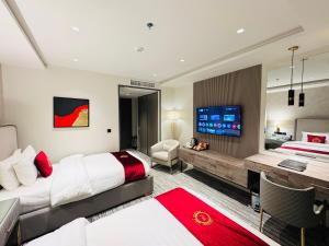 a hotel room with a bed and a desk at Montressa Hotel F-7 Islamabad in Islamabad