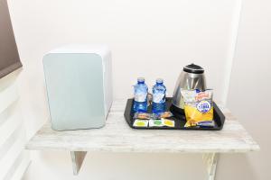 a tray of food and bottled water on a table at Apartamento Uso Turistico Ancora de Oro in Fisterra