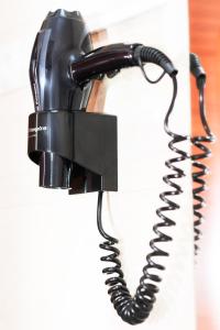 a black rotary phone hanging on a wall at Apartamento Uso Turistico Ancora de Oro in Fisterra