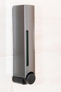 a metal door opener on a white wall at Apartamento Uso Turistico Ancora de Oro in Fisterra +11 photos